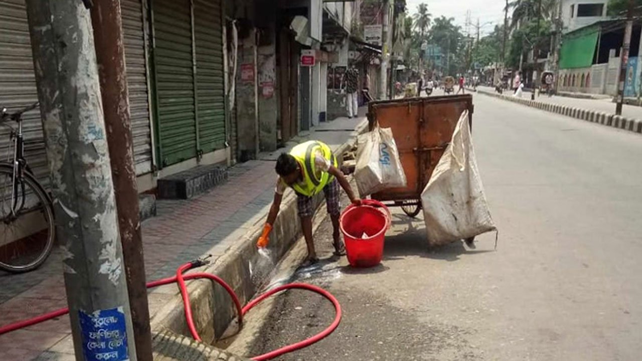 Cleaners removing animal sacrifice waste