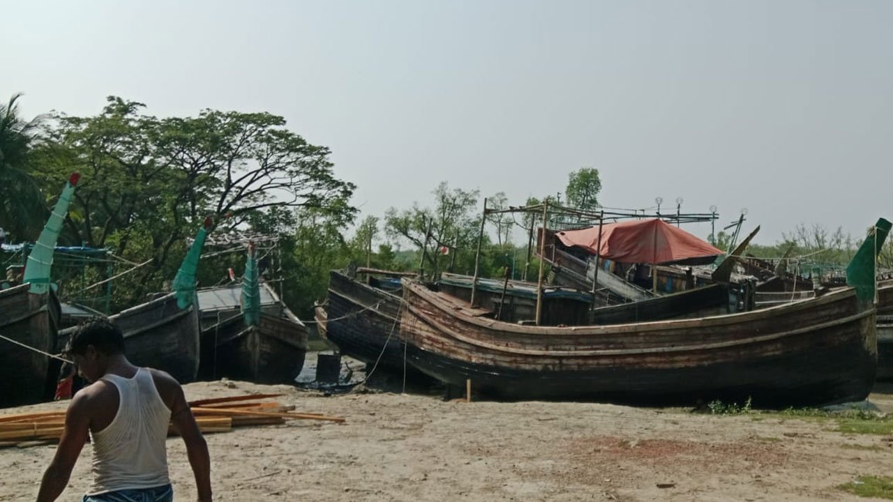 Rows of fishing boats sit idly at various piers on the Bankkhali River in Cox's Bazar.