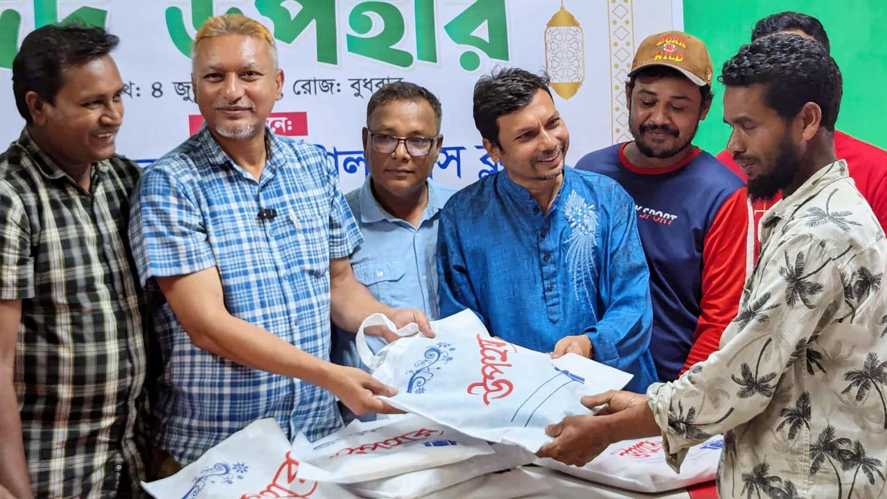 Press Club President and General Secretary handing over Eid gifts to newspaper hawkers